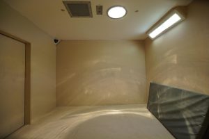 photo bare prison cell with only a mattress