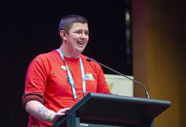 Self advocate presenting on a stage
